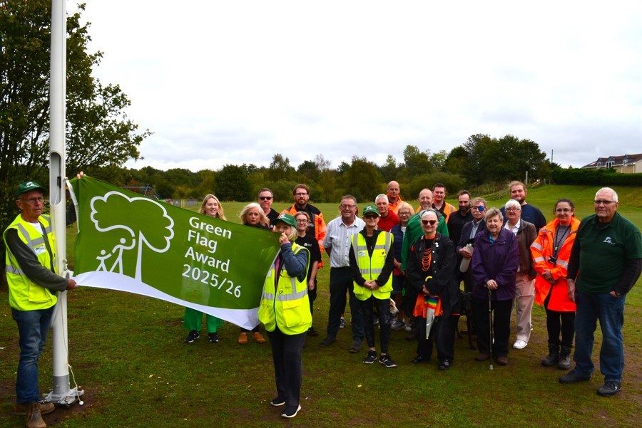 People standing by the Green Flag for Quarry Park